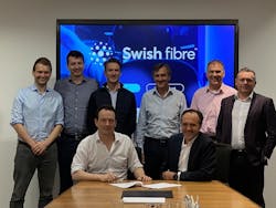 Rob Skinner, Octopus, with Brice Yharrassarry, CEO of Swish Fibre, signing their new agreement supported by their respective teams. Rob Skinner, Octopus, with Brice Yharrassarry, CEO of Swish Fibre, signing their new agreement supported by their respective teams.