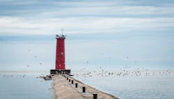 A flock of birds flying around the lighthouse in Sheboygan, Wisconsin. A flock of birds flying around the lighthouse in Sheboygan, Wisconsin.