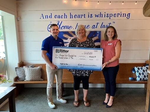 Colleen Nick of the Morgan Nick Foundation accepts a $5,000 donation from Ritter Communications Marketing Coordinator Melissa Cole (far left).