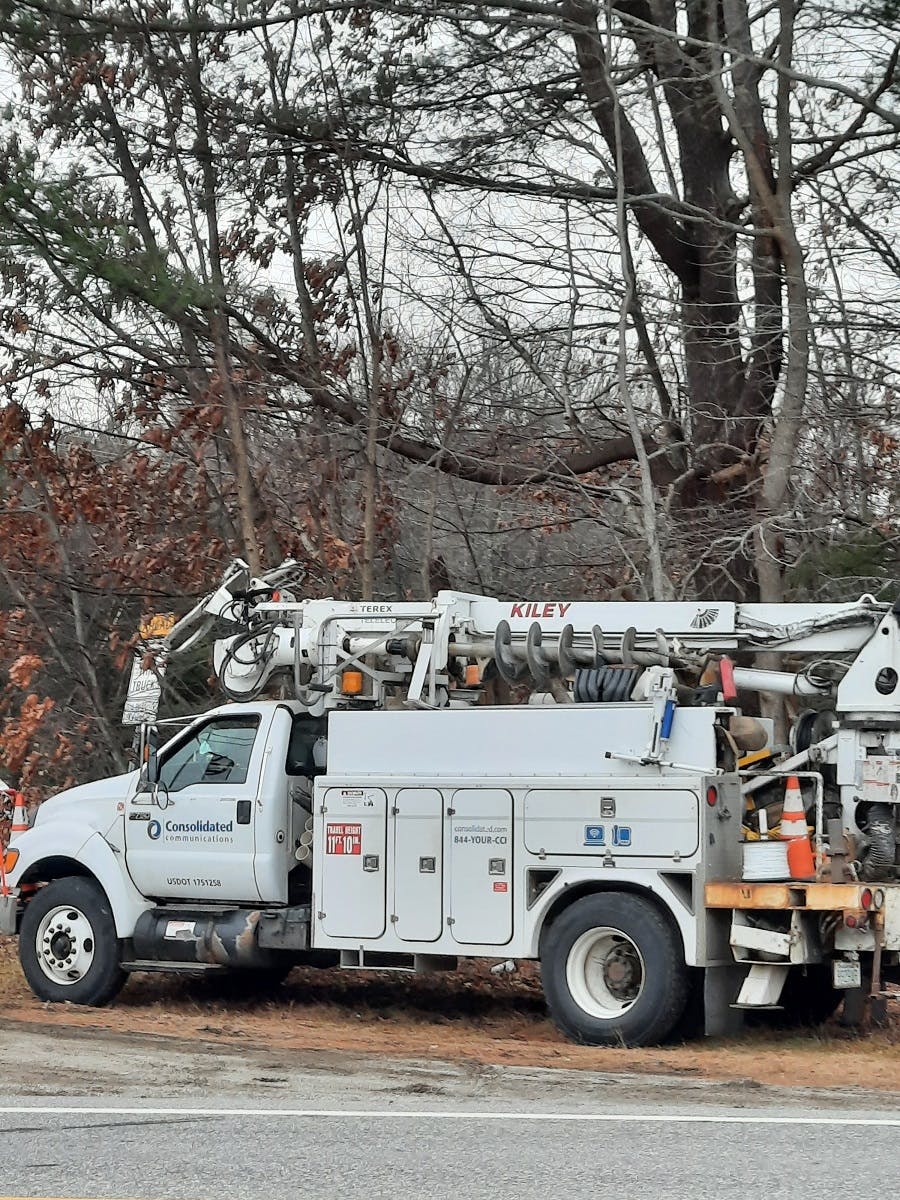 A Consolidated Communications Fidium Fiber truck parked roadside in Manchester, NH.