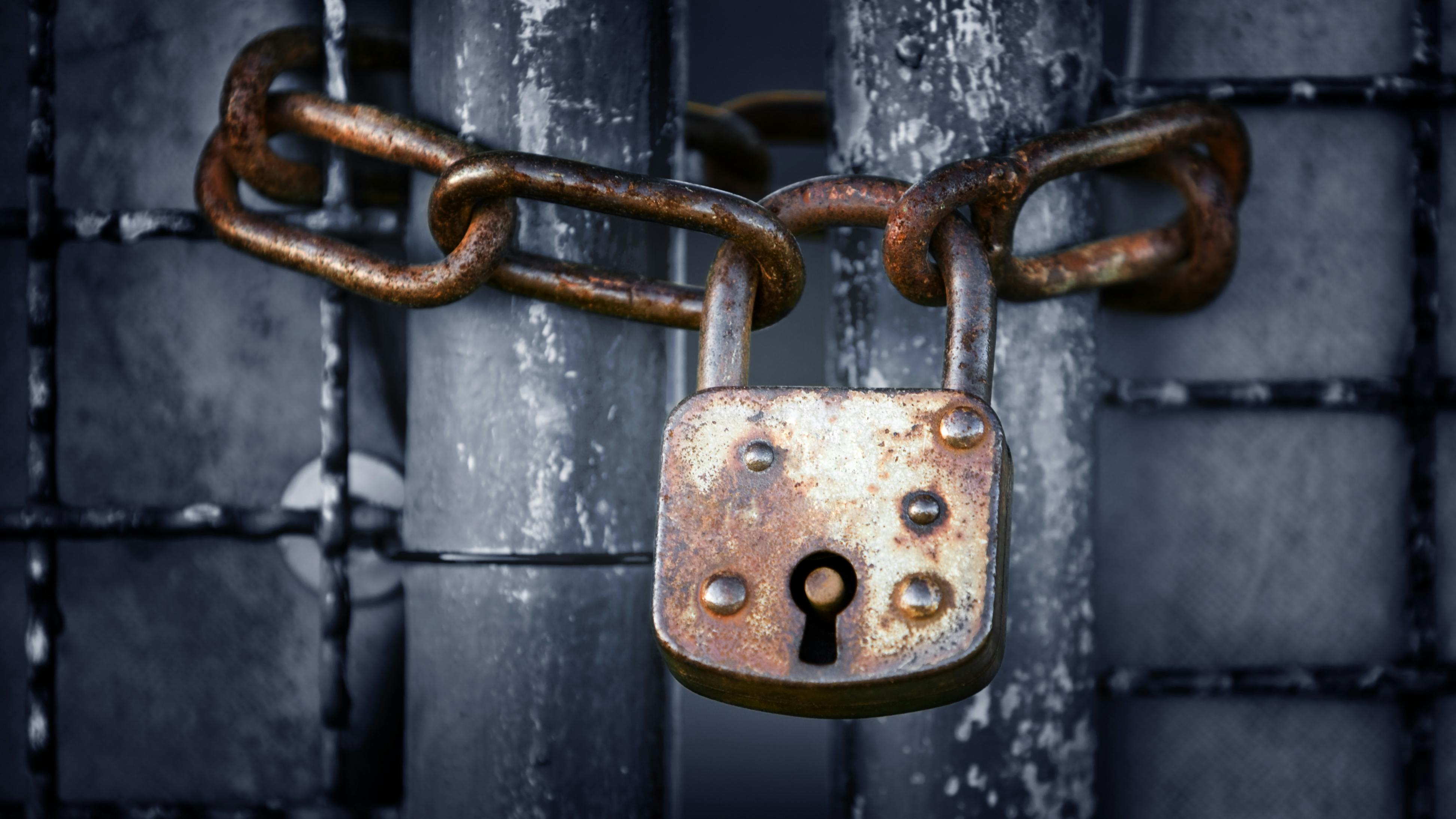 An old, rusty padlock and chain.