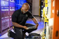 Michael Moore, a Kinetic Technician, confirms the new multi-gigabit capable card is ready for installation.