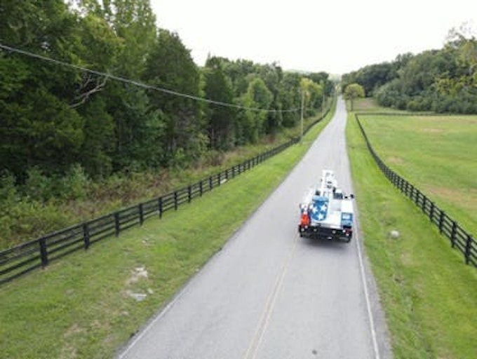 A United Communications aerial lift truck en route to a fiber broadband installation.